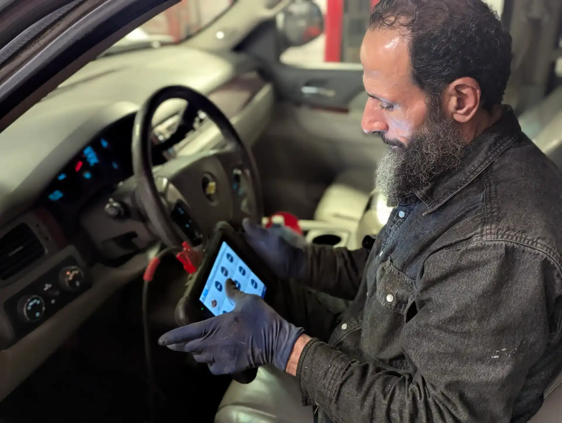 Friendly mechanic smiling in a bright shop